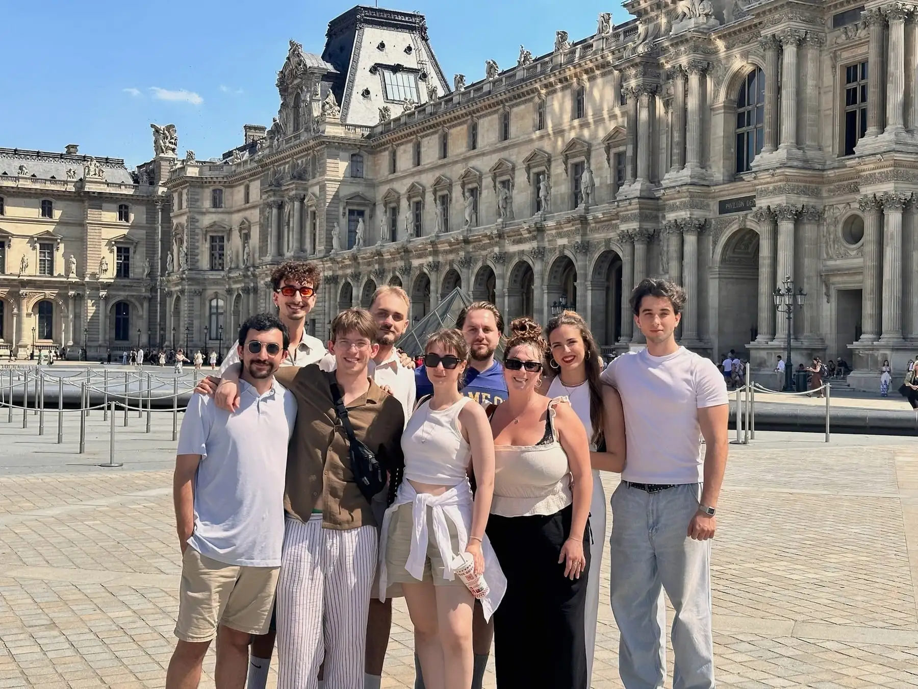 Team members standing together in a courtyard.
